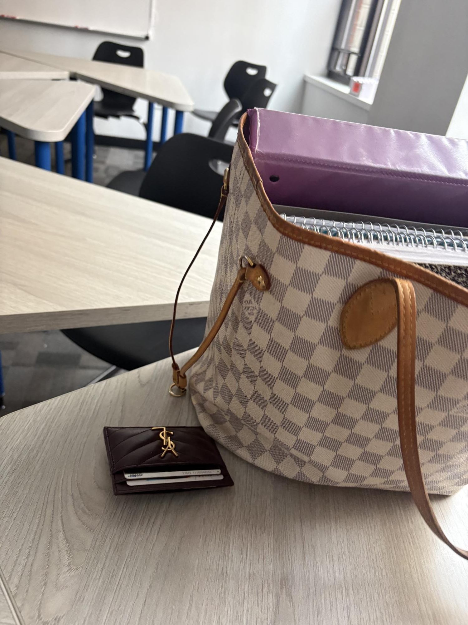 Louis Vuitton bag and Yves Saint Laurent wallet seen at school.