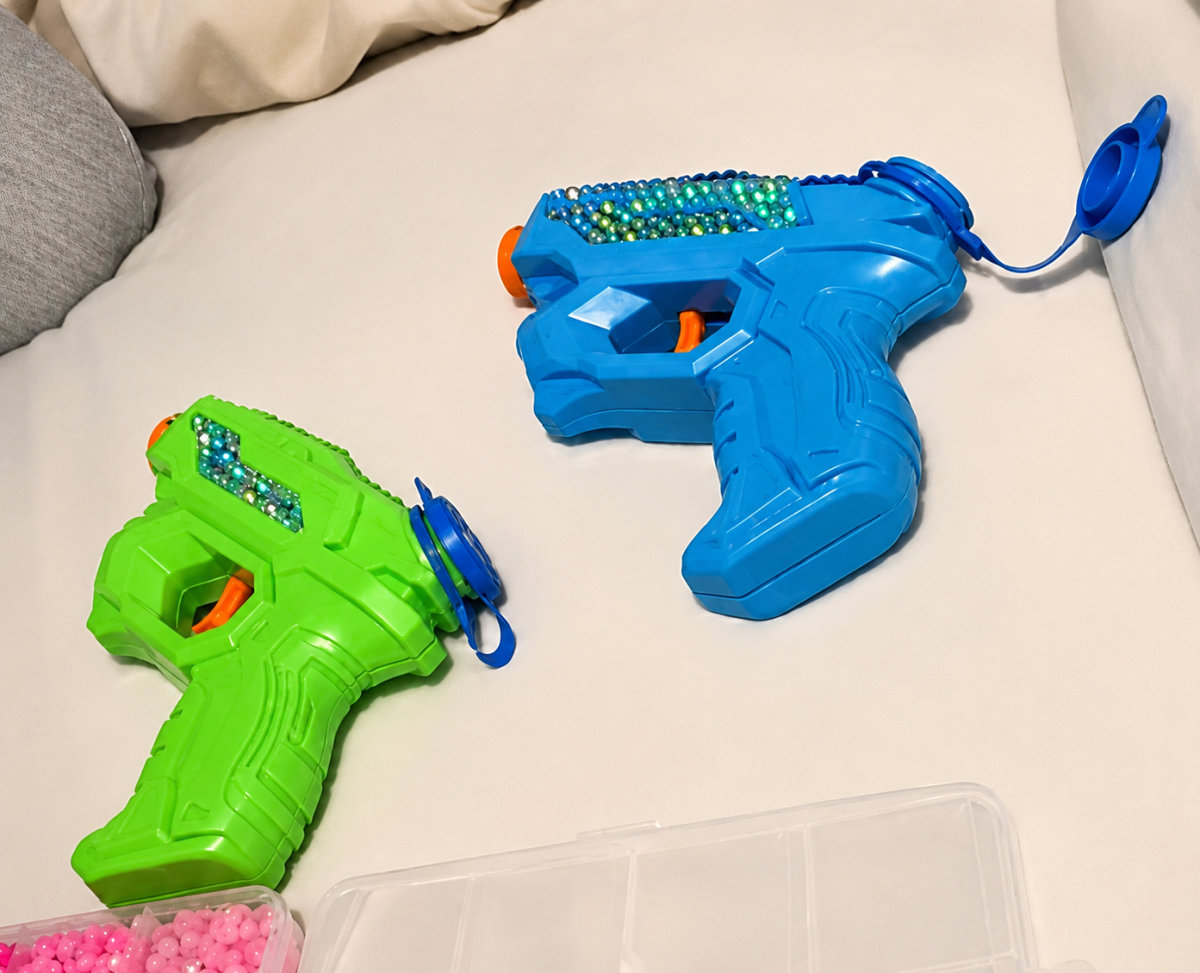 The bedazzled water guns, customized for Senior Assassin, of seniors Julia Steffen (right) and Lauren Rosenberg (left).