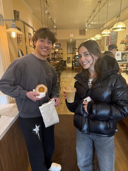Carla holds her latte next to junior Lev Lippitz, who is holding his Danish from La Fournette.