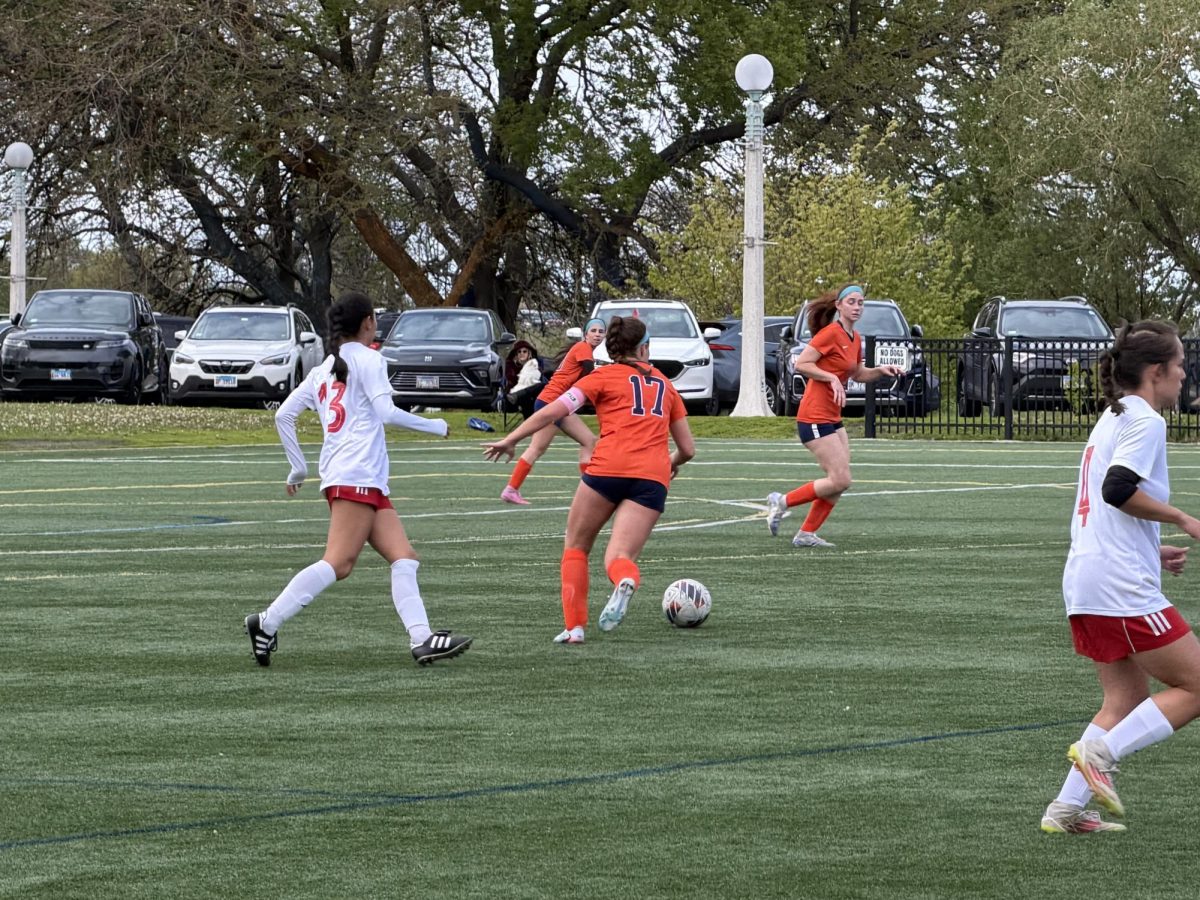 Senior Lauren Rosenberg (17) dribbles the soccer ball down the field.