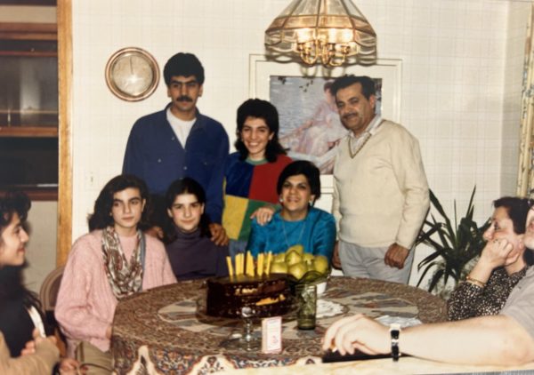 Laily and Tanier Uribe's family sits around the table in their home in Iran.