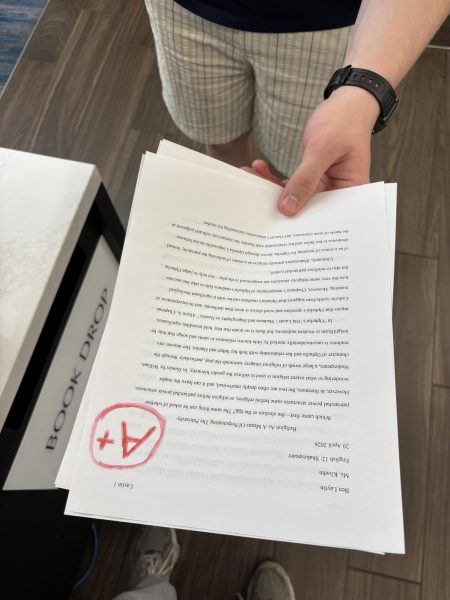 A student looks at a fake grade on his real paper